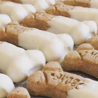 Medium Sizes White Confection And Peanut Butter  Dog Bones  · Medium size dog bones dipped in our amazing mixture of white confection and peanut butter.