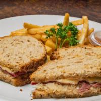 Reuben Sandwich · Served on rye bread with corn beef, Swiss cheese, sauerkraut, Russian dressing, and French f...