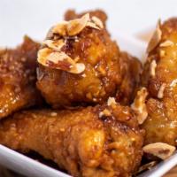 Soy Garlic Chicken Wings · Crispy fried chicken wings tossed in soy garlic glaze. Served with sides of Korean pickled r...
