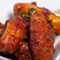 Mama Gon' Mad Chicken Wings · Crispy fried wings tossed in extremely spicy house special sauce. Served with Korean pickled...