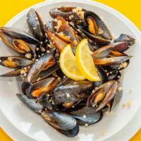 Steamed Mussels · Served with garlic butter.