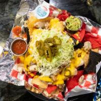 Ground Beef Nachos · Crispy tortilla chips covered with melted cheeses, shredded lettuce, diced tomatoes, back ol...