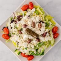 Greek Salad · Mixed garden style greens topped with Feta cheese, stuffed grape leaves, kalamata olives, re...