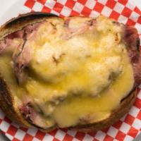 Reuben · Hot corned beef or pastrami topped with Swiss cheese and sauerkraut on grilled rye with Russ...