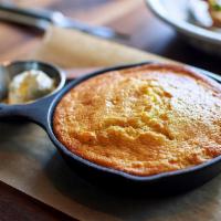 Skillet Cornbread · Sweet & savory cornbread is served with house-churned North Dakota honey butter sprinkled wi...