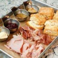 Ham & Biscuits · Our scratch-made buttermilk biscuits with house-cured ham and proscuitto, served with tart j...