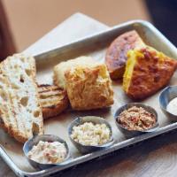 Churned Spreads & Breads · An assortment of our scratch-made farm breads & spreads: two pieces of our scratch-made, gri...