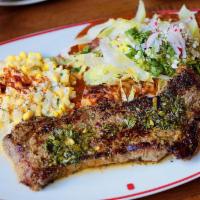 Steak & Enchiladas · Our NY strip served with two chicken enchiladas with salsa verde,  avocado salad, and cotija...