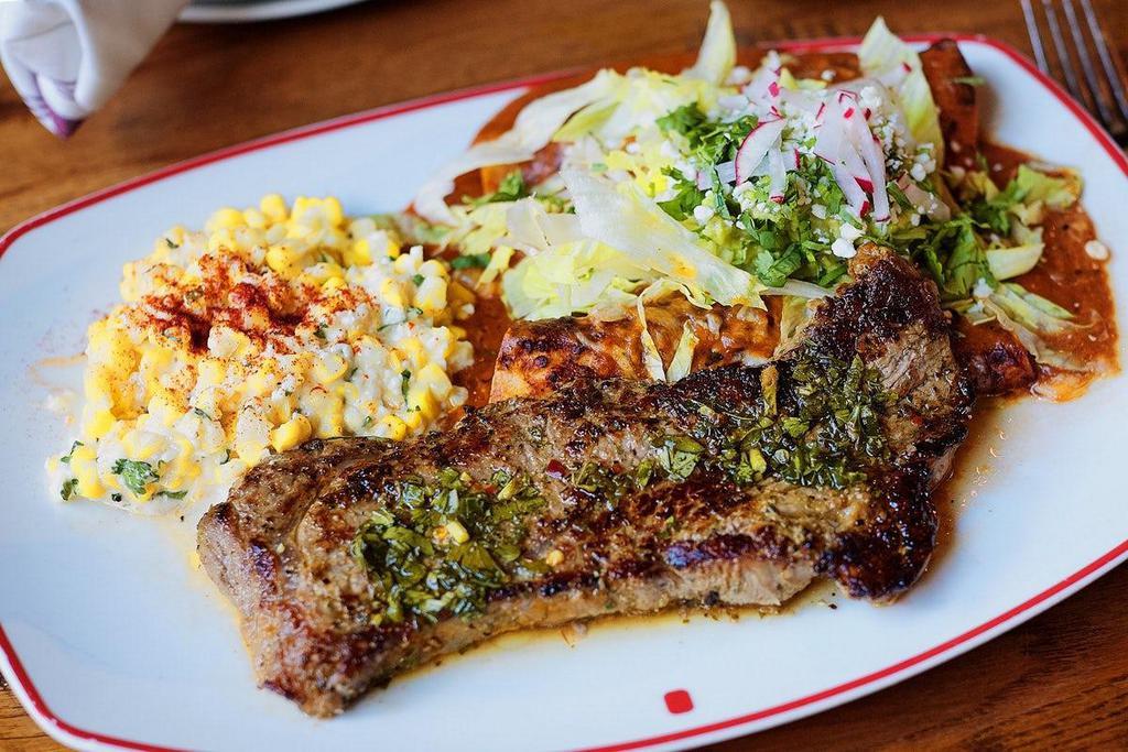 Steak & Enchiladas · Our NY strip served with two chicken enchiladas with salsa verde,  avocado salad, and cotija cheese. Served with street corn..