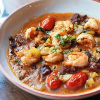 Shrimp & Grits, Andouille · Sautéed shrimp and andouille sausage cooked with green and red tomatoes in a slightly-spicy ...