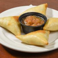 Sambousa With Meat · Four pieces of fried pasty filled with savory ground beef and spices.