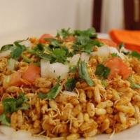 Bhel Puri · Rice puffs and crispy flour noodles tossed with tamarind and cilantro chutneys.