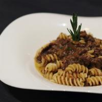 A Genovese · Fusilloni pasta, braised beef caramelized onion ragú, Parmigiano Reggiano.