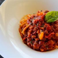Bucatini Alla Amatriciana · Hollow thick spaghetti, tomato ragú, guanciale, onions, Pecorino Romano.