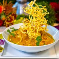 Khao Soi Chicken · Egg noodles with leg chicken in red curry sauen rede d enions seur cobbope centre tapped wit...