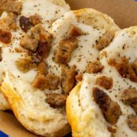 Biscuits + Groovy · Three freshly baked buttermilk biscuits smothered in white pepper gravy topped with sausage ...