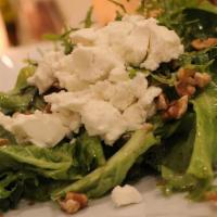 Campo Caprino · Mescalin greens topped with goat cheese and walnuts with a homemade lemon basil vinaigrette ...