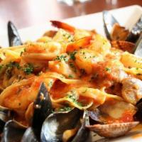 Linguini Alla Scoglio · Shrimp, scallops, mussels and clams sauteed in a spicy tomato sauce with our homemade lingui...