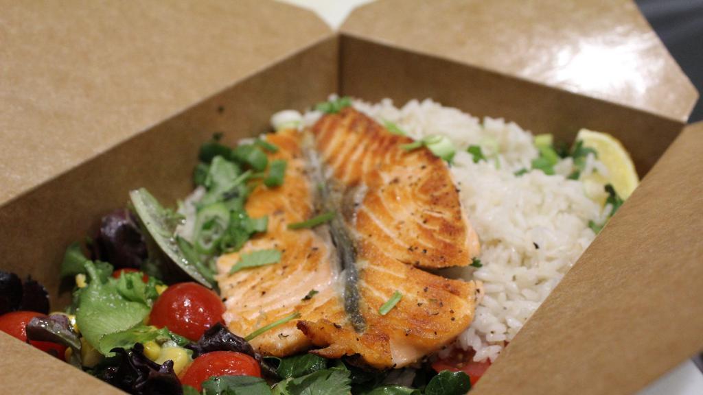 Salmon Bowl · A 6 ounce cut of our freshest salmon grilled to tenderness and served over a bed of crispy salad greens and jasmine rice topped with corn, tomato, cilantro, sweet basil oil and green onion.
