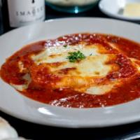 Manicotti · Pasta rolled and stuffed with parmesan, ricotta and melted mozzarella.