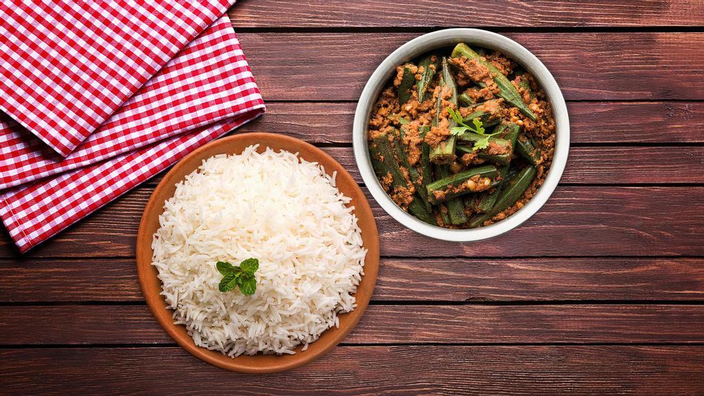 Okra Masala Rice Bowl  · A healthy dish made of okra, spices, onions & tomatoes stir fried and served with aromatic basmati rice serving as the perfect comfort food