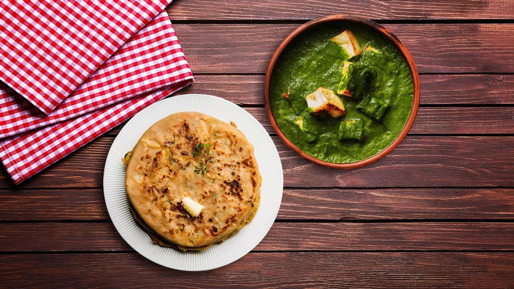 Spinach Cottage Cheese & Paratha · A flavourful yet spicy spinach curry with fresh chunks of cottage cheese, served with parathas.