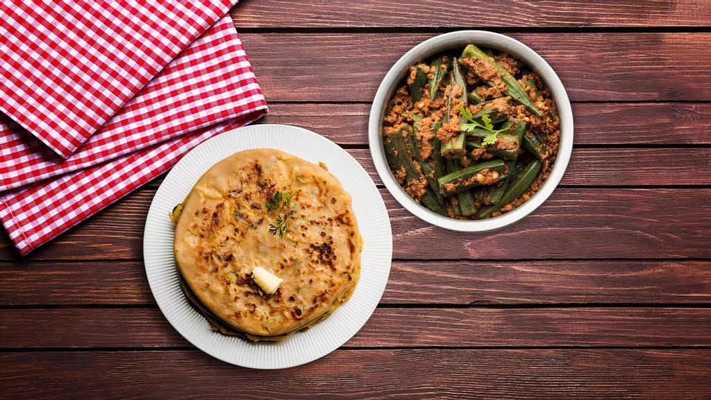 Okra Masala & Paratha · A healthy dish made of okra, spices, onions & tomatoes stir fried and served with hot parathas serving as the perfect comfort food