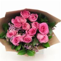 Pink Roses Bouquet · One dozen roses and accenting flowers and greenery are presented in a hand-tied bouquet.