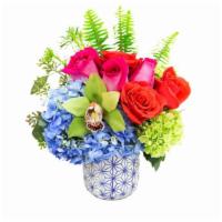 Petite Senesation Vase Arrangement · Orange and pink roses, two different kinds of hydrangea, a cymbidium orchid and more are fea...