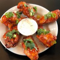 Thai Chicken Wings · Tossed with a glaze of Thai curry paste, lemongrass, brown sugar, soy sauce, and coconut milk.