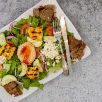 Mediterranean Salad · A hearty mixed green salad, fresh tomatoes, red onion, cucumber, hummus, kalamata olives top...