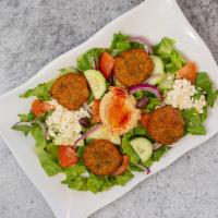 Falafel Salad · Hearty mix of green romaine lettuce, fresh tomatoes, sliced cucumber, red onion topped with ...