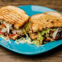 Bbq Chicken Panini · Hand pulled savory chicken on a bed of provolone, topped with tomato, BBQ sauce, and shredde...