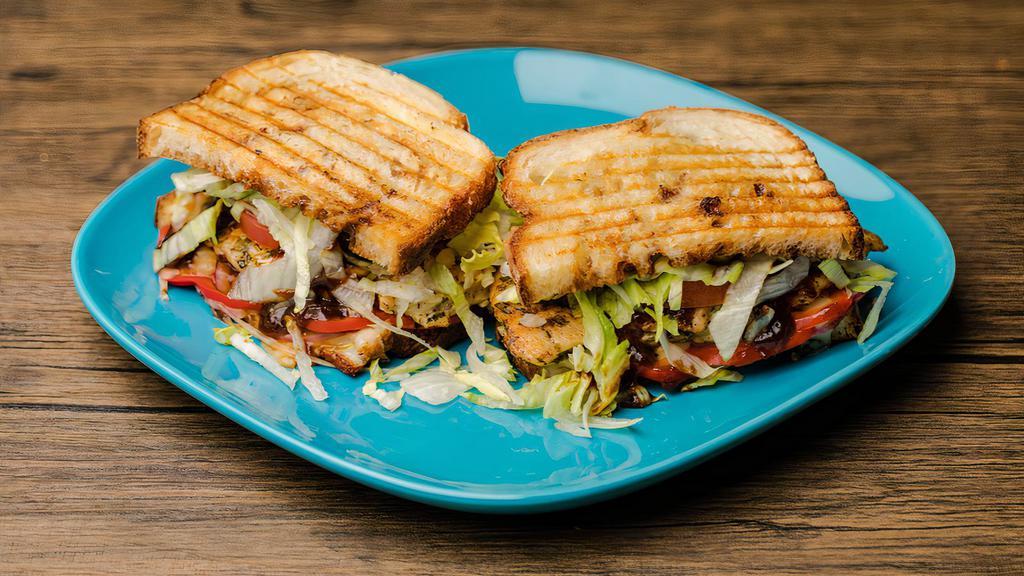 Bbq Chicken Panini · Hand pulled savory chicken on a bed of provolone, topped with tomato, BBQ sauce, and shredded lettuce.