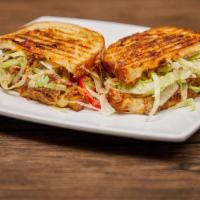 Bbq Pulled Pork Panini · Zesty BBQ dressed pulled pork, topped with melty pepper jack, tomato, and shredded lettuce.