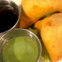 Veggie Samosa · Two Pastry puff filled with peas, potatoes and Indian spices, served w/ a cilantro chutney.