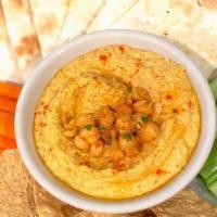 Chana Hummus · Homemade chickpea puree served w/tortilla chips, tandoor Naan, Olive oil, carrots and celery.