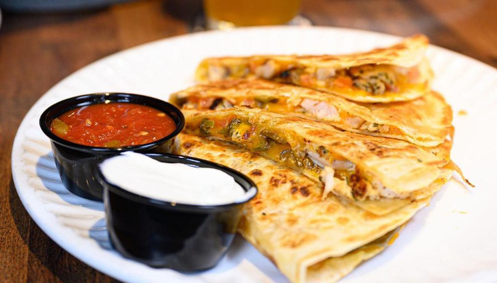 Quesadilla · Large Flour Tortilla stuffed with Cheddar Jack Cheese,. Caramelized Onions, Green Peppers, and Tomato. Served with. Sour Cream and Salsa upon request