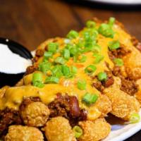 Chili Cheese Tots · Crispy fried Tater Tots topped with Chili, our signature Queso,. and Scallions