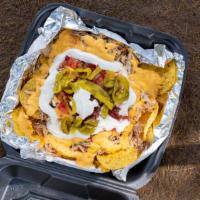 Chicken Nachos · Chips with cheese meat and a variety of toppings.