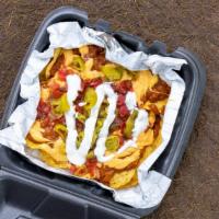 Chili Cheese Nachos · Chips with cheese and a variety of toppings.