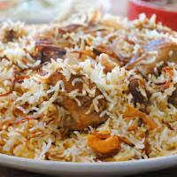 Chicken Biryani · Popular. Long grain basmati rice cooked with mild spiced chicken, saffron, nuts, and raisins.