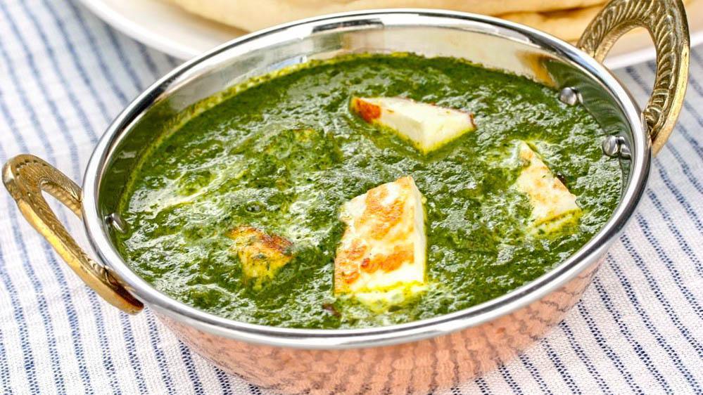 Saag Paneer · Homemade cottage cheese cubes cooked in freshly chopped spinach blended sauce with mild herbs.