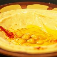 Hummus · Pureed chickpeas, tahini, garlic, lemon, topped with olive oil.