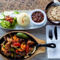 Sizzling Fajitas · All fajitas are grilled to perfection over a bed of sauteed green peppers and red onions, se...