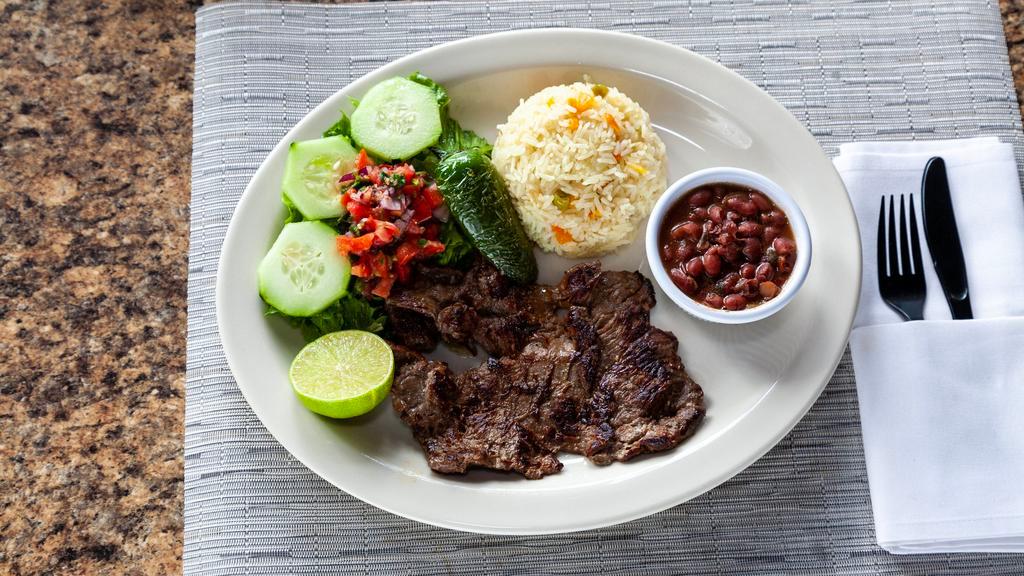 Carne Asada / Grilled Skirt Steak · Served with rice, salad and black beans.