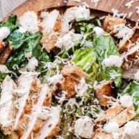 Chicken Caesar · Crisp romaine lettuce, parmesan, croutons topped with grilled chicken breast served with cae...
