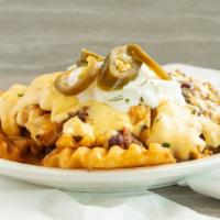 Texas Fries · Waffle Fries with Chili, Cheese Sauce, Sour Cream and Jalapenos.