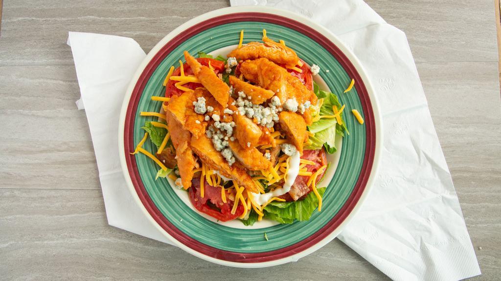 Buffalo Chicken Salad · spicy chicken strips over romaine lettuce with tomato, cucumber, crumbled blue cheese, bacon, and cheddar cheese with bleu cheese dressing
