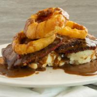 Meatloaf Tower · our homemade meatloaf, mashed potatoes and beer battered onion rings served over white bread...
